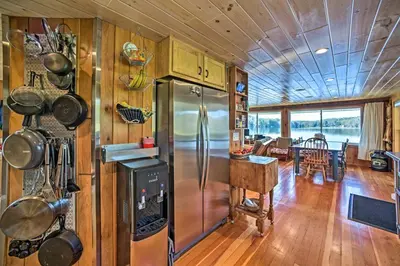 a kitchen with a refrigerator and a dining room at BBQ Ready Lakeside Milford Home with Paddleboat in Milford