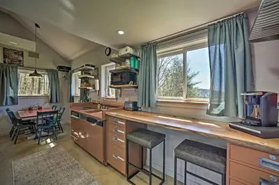 a kitchen with a counter and a table with chairs at Fire Pit and Gas Grill Secluded Studio in Milford! in Milford