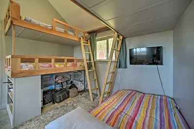 a small room with bunk beds and a bed at Fire Pit and Gas Grill Secluded Studio in Milford! in Milford
