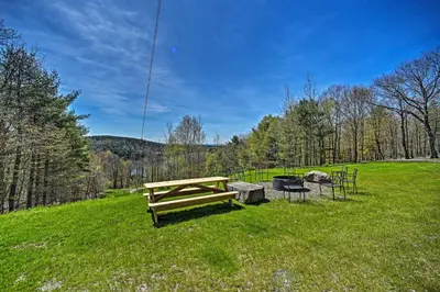 a picnic table and a grill in a field at Fire Pit and Gas Grill Secluded Studio in Milford! in Milford
