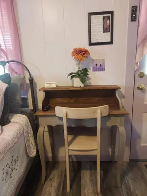 a desk with a chair next to a bed at Serenity Motel in Shaftsbury