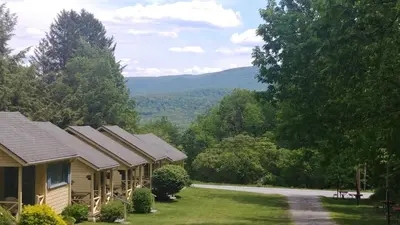 a row of houses with mountains in the background at Serenity Motel in Shaftsbury