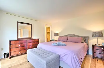 a bedroom with a bed and a dresser and a mirror at Chic Dover Home with Hot Tub 1 Mi to Golf! in West Dover