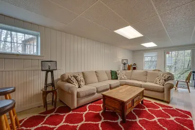a living room with a couch and a table at Chic Dover Home with Hot Tub 1 Mi to Golf! in West Dover