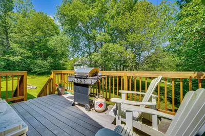 a grill and two chairs on a wooden deck at Chic Dover Home with Hot Tub 1 Mi to Golf! in West Dover