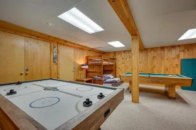 a pool table in a room with wooden walls at Chic Dover Home with Hot Tub 1 Mi to Golf! in West Dover