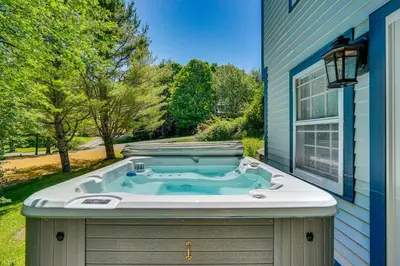 a jacuzzi tub sitting outside of a house at Chic Dover Home with Hot Tub 1 Mi to Golf! in West Dover