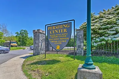 a sign on a pole next to a fence at Updated Home with Patio Half Mile to West Point in Highland Falls