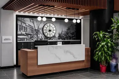 a lobby with a large clock on the wall at Four Points by Sheraton Flushing in Queens