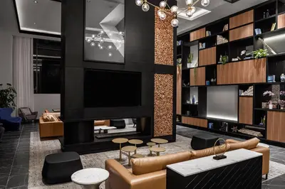 a living room with a couch and a tv at Four Points by Sheraton Flushing in Queens