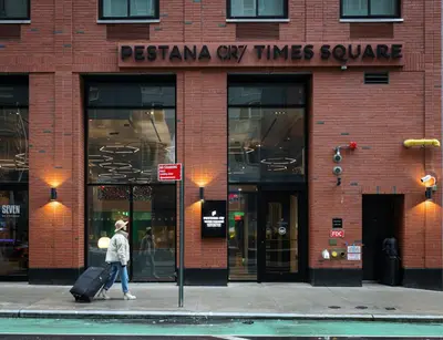 a person walking on a sidewalk in front of a store at Pestana CR7 Times Square in New York