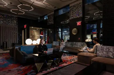 a group of people sitting in a lobby at Pestana CR7 Times Square in New York