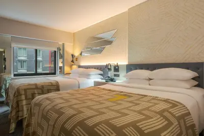 a hotel room with two beds and a window at Pestana CR7 Times Square in New York