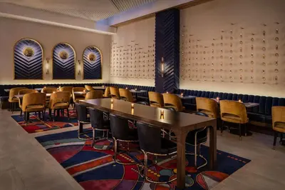 a row of tables and chairs in a room at Motto by Hilton New York City Chelsea in New York