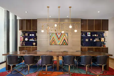 a dining room with a large table and chairs at Motto by Hilton New York City Chelsea in New York