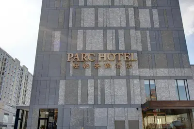 a building with a sign on the side of it at The Parc Hotel in Queens