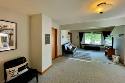 a living room with a couch and a chair at Lakeside Berkshires Home Near Hiking and Skiing! in Lanesborough