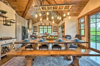 a large dining room with a wooden table in a kitchen at Elegant Mtn Chalet with Deck 1 Mi to Mt Snow! in Dover