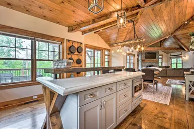 a kitchen with wooden ceilings and a dining room at Elegant Mtn Chalet with Deck 1 Mi to Mt Snow! in Dover