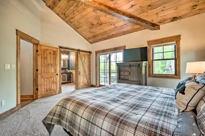 a bedroom with a bed and wooden ceilings at Elegant Mtn Chalet with Deck 1 Mi to Mt Snow! in Dover