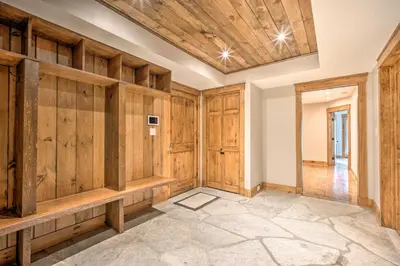 a large room with wooden walls and wooden cabinets at Elegant Mtn Chalet with Deck 1 Mi to Mt Snow! in Dover