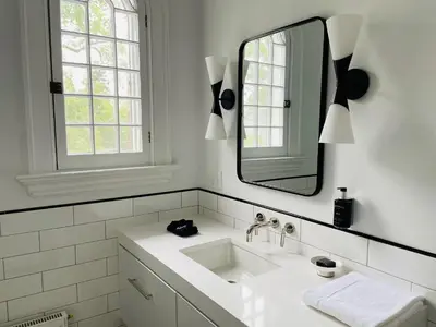 a white bathroom with a sink and a mirror at The Amelia in Hudson