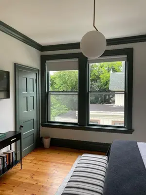 a bedroom with two windows and a bed in it at The Amelia in Hudson