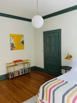 a bedroom with a bed and a green door at The Amelia in Hudson