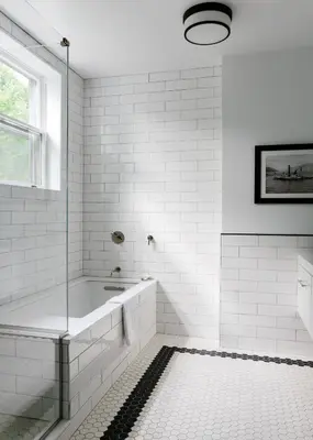 a white bathroom with a tub and a sink at The Amelia in Hudson