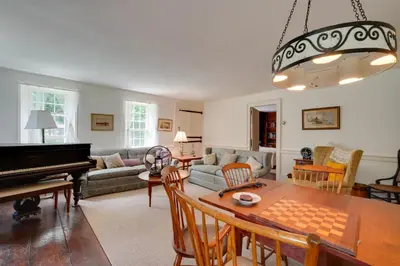 a living room with a table and a piano at Sky Parlor Farm on 480 Acres with Fire Pit! in Salem