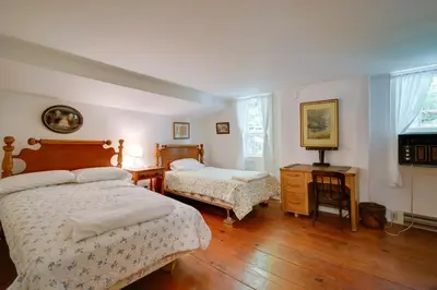 a bedroom with two beds and a desk and a television at Sky Parlor Farm on 480 Acres with Fire Pit! in Salem