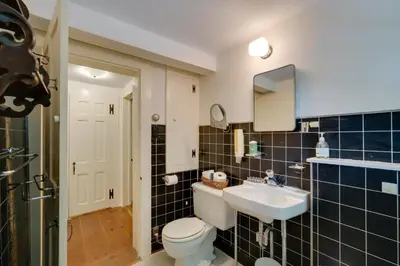 a bathroom with a white toilet and a sink at Sky Parlor Farm on 480 Acres with Fire Pit! in Salem