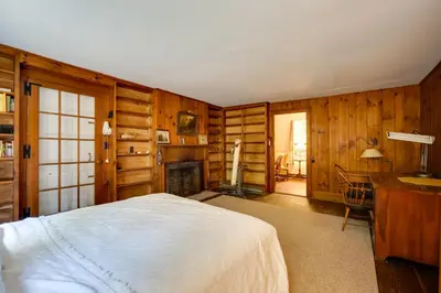 a bedroom with a bed and a desk and a fireplace at Sky Parlor Farm on 480 Acres with Fire Pit! in Salem
