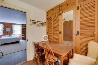 a dining room with a wooden table and a bedroom at Sky Parlor Farm on 480 Acres with Fire Pit! in Salem