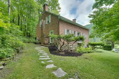 an old brick house with a stone path in front of it at Sky Parlor Farm on 480 Acres with Fire Pit! in Salem