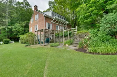 an old brick house with a lawn in front of it at Sky Parlor Farm on 480 Acres with Fire Pit! in Salem