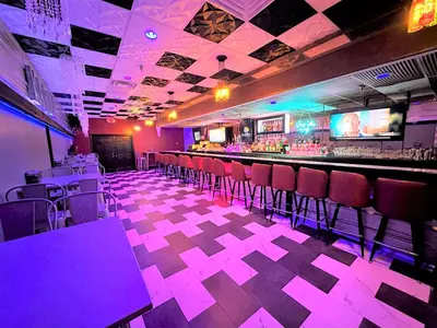 a bar with purple lighting in a restaurant at Albany Airport Inn in Albany
