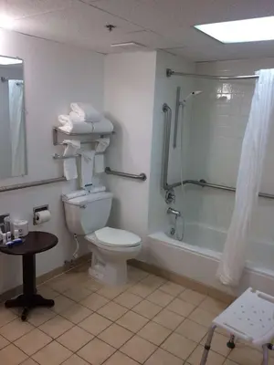 a bathroom with a toilet and a shower at Albany Airport Inn in Albany