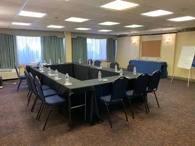 a meeting room with a long table and chairs at Albany Airport Inn in Albany