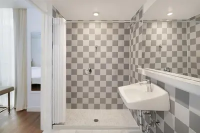a bathroom with a sink and a shower at Best Western Premier Empire State Hotel in New York