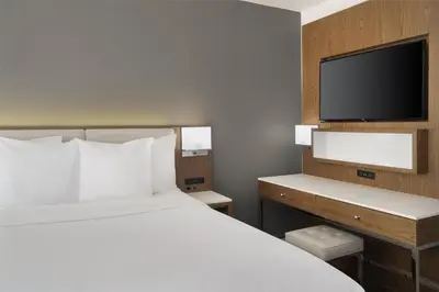 a hotel room with a bed and a flat screen tv at Best Western Premier Empire State Hotel in New York