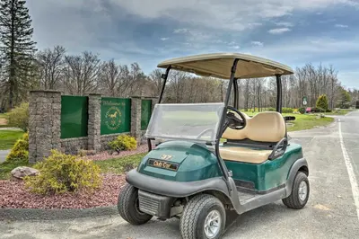 a golf cart parked on the side of a road at Deck and Pool Access Welcoming Poconos Retreat in Tobyhanna