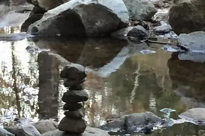 a stack of rocks in a stream of water at Secluded Sanctuary in West Wardsboro