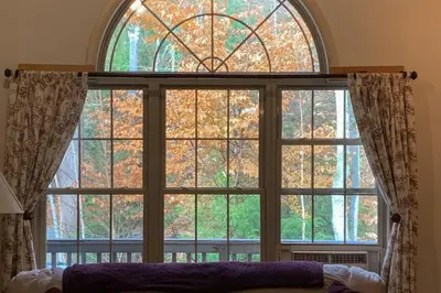 a large window with a view of trees at Secluded Sanctuary in West Wardsboro