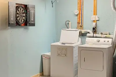 a room with a machine and a dart board on the wall at Secluded Sanctuary in West Wardsboro