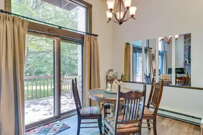 a dining room with a table and chairs and a large window at 4 Mi to Windham Mountain Ski Getaway! in Windham