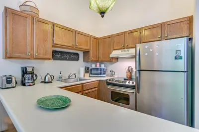 a kitchen with wooden cabinets and a stainless steel refrigerator at 4 Mi to Windham Mountain Ski Getaway! in Windham