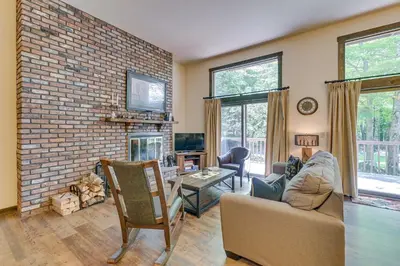 a living room with a fireplace and a brick wall at 4 Mi to Windham Mountain Ski Getaway! in Windham