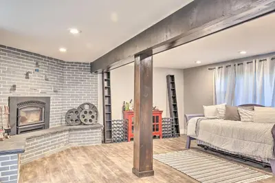 a bedroom with a bed and a fireplace at Modern NY Home with Views By Hudson Valley Hiking! in Hopewell Junction