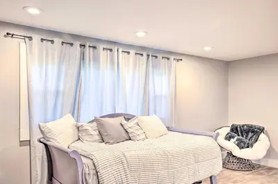 a bedroom with a bed and a window with curtains at Modern NY Home with Views By Hudson Valley Hiking! in Hopewell Junction